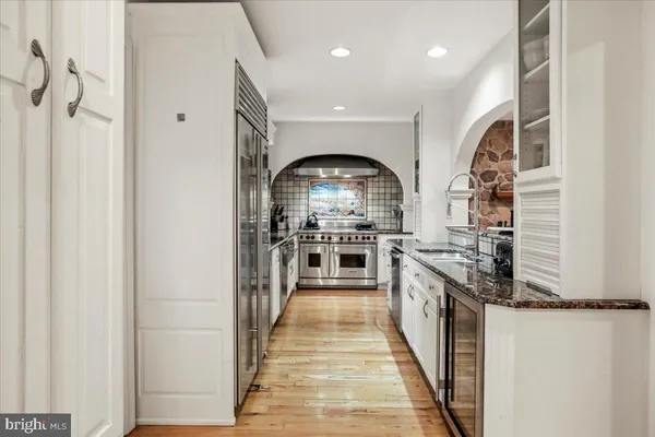 a stove top oven sitting inside of a kitchen