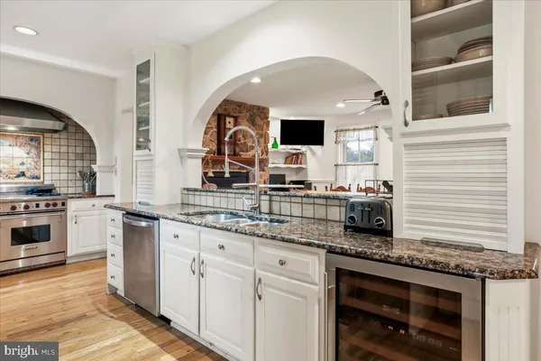 a stove top oven sitting inside of a kitchen