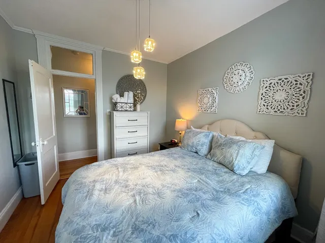 a bedroom with a bed and a chandelier