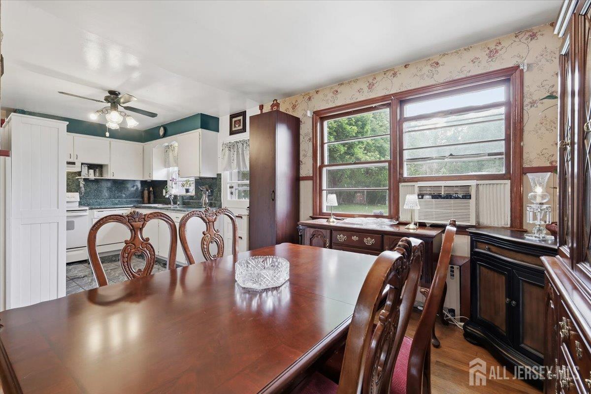33 Ellison Road Somerset, NJ 08873 - Photo 7 of 38 a kitchen with a table chairs stove and refrigerator