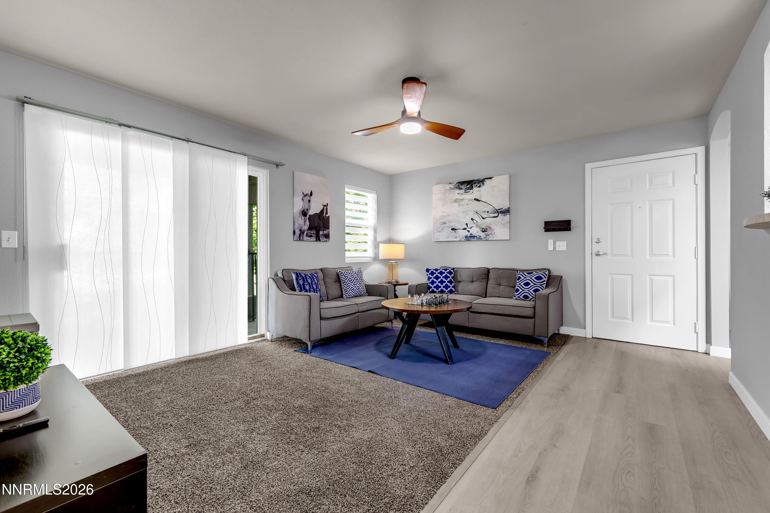 6850 Sharlands Avenue, Unit E 2022 Reno, NV 89523 - Photo 2 of 19 a living room with furniture and a potted plant