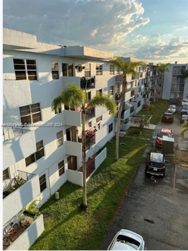 1221 Southwest 122nd Avenue, Unit 401 Miami, FL 33184 - Photo 1 of 22 a view of multiple houses with a yard