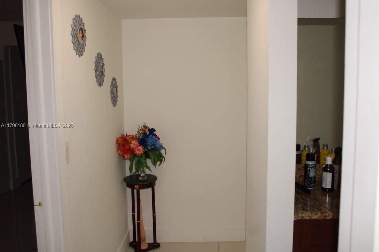 1221 Southwest 122nd Avenue, Unit 401 Miami, FL 33184 - Photo 12 of 22 a view of a hallway with a flower pot