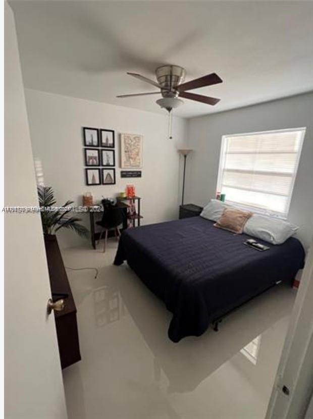 1221 Southwest 122nd Avenue, Unit 401 Miami, FL 33184 - Photo 14 of 22 a bedroom with a bed gym equipment and a window