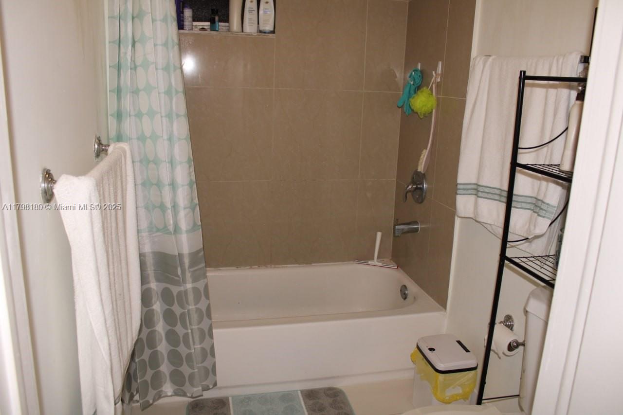 1221 Southwest 122nd Avenue, Unit 401 Miami, FL 33184 - Photo 16 of 22 a bathroom with bathtub and shower
