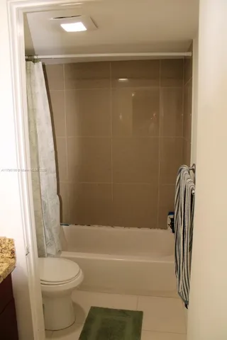 a bathroom with a toilet and a bathtub