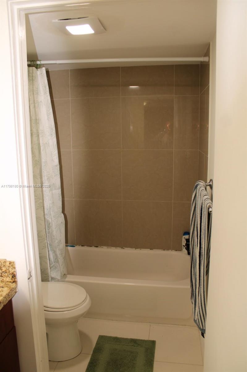 1221 Southwest 122nd Avenue, Unit 401 Miami, FL 33184 - Photo 17 of 22 a bathroom with a toilet and a bathtub
