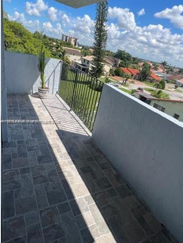 1221 Southwest 122nd Avenue, Unit 401 Miami, FL 33184 - Photo 19 of 22 a view of balcony with furniture