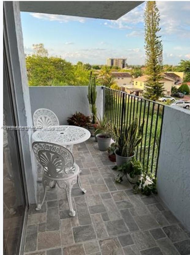 1221 Southwest 122nd Avenue, Unit 401 Miami, FL 33184 - Photo 20 of 22 a view of a balcony with chairs