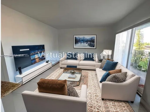 a living room with furniture and a large window