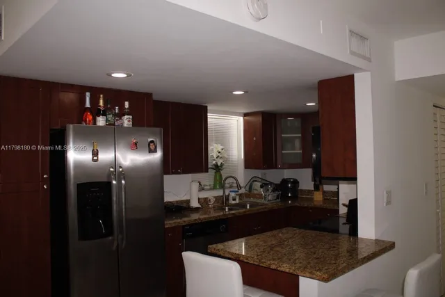 a kitchen with refrigerator and sink
