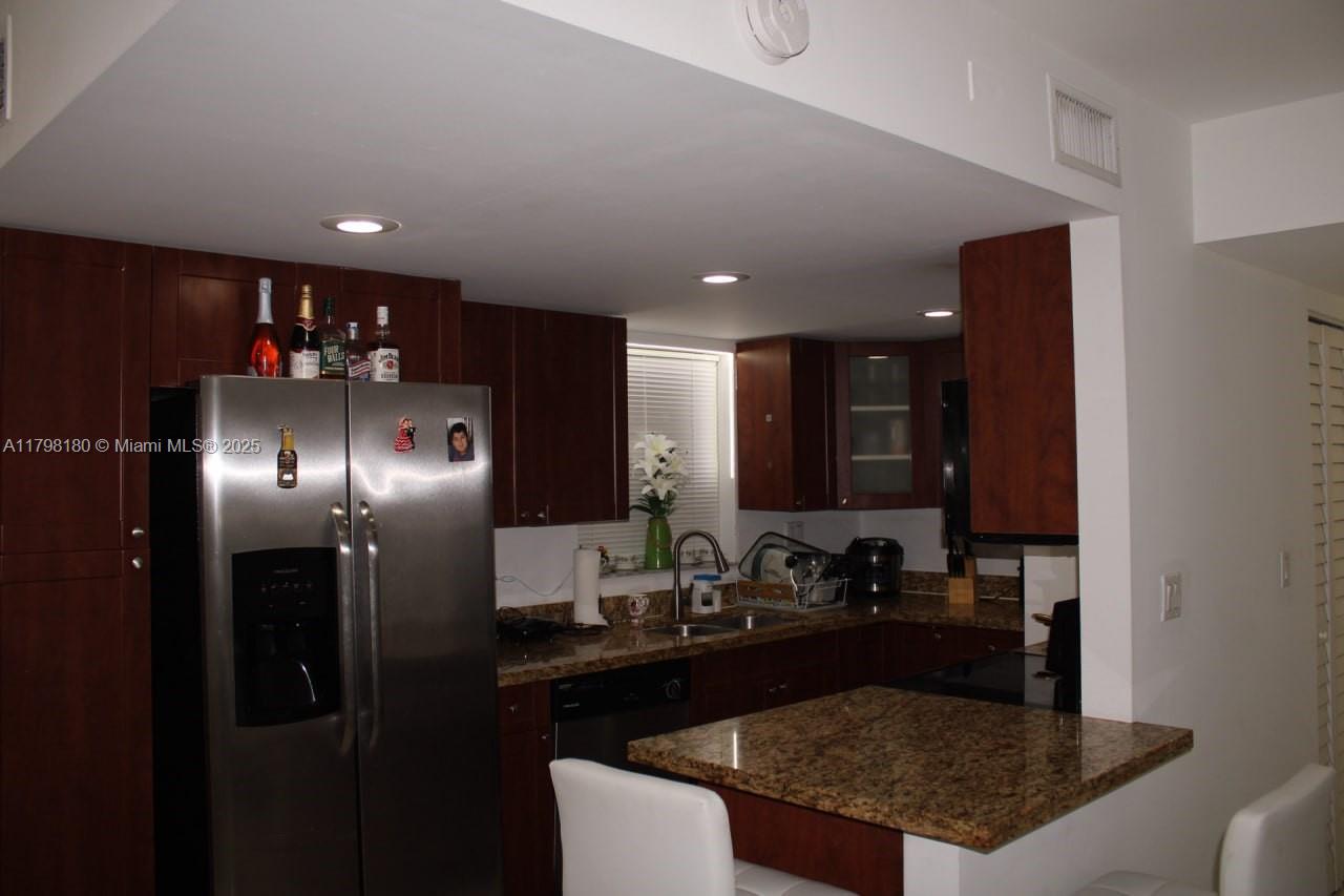 1221 Southwest 122nd Avenue, Unit 401 Miami, FL 33184 - Photo 5 of 22 a kitchen with refrigerator and sink