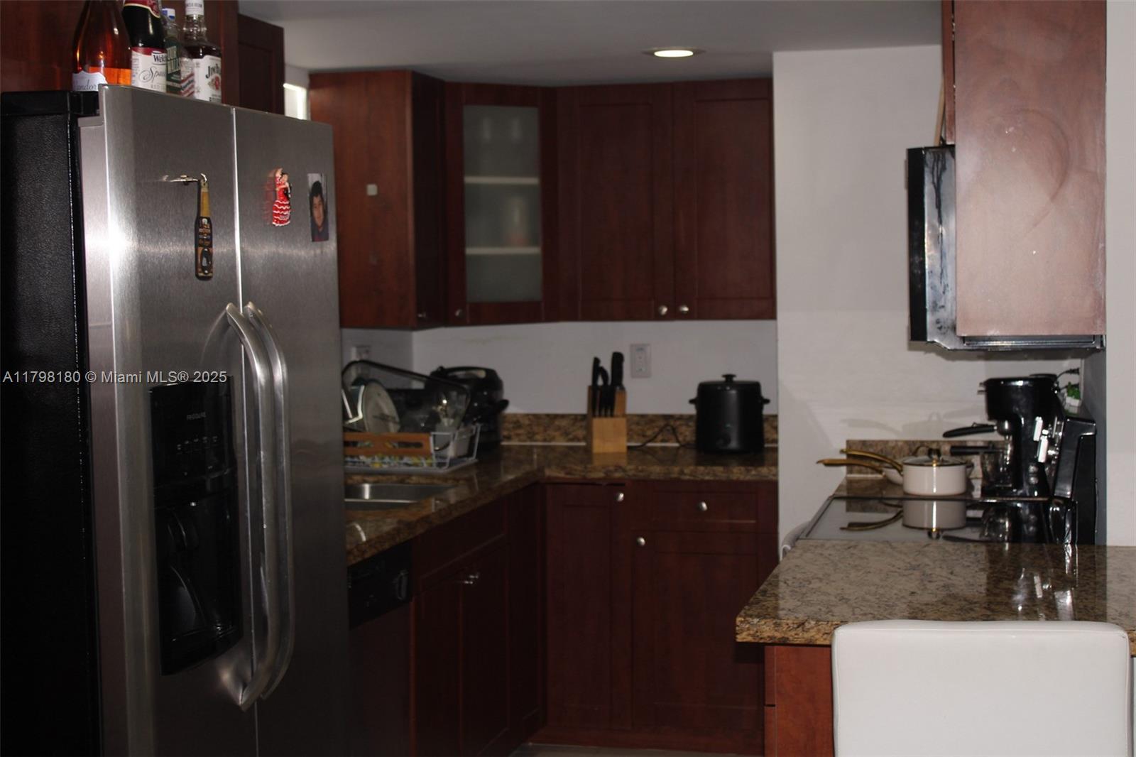 1221 Southwest 122nd Avenue, Unit 401 Miami, FL 33184 - Photo 7 of 22 a kitchen with stainless steel appliances granite countertop a refrigerator a sink and a stove