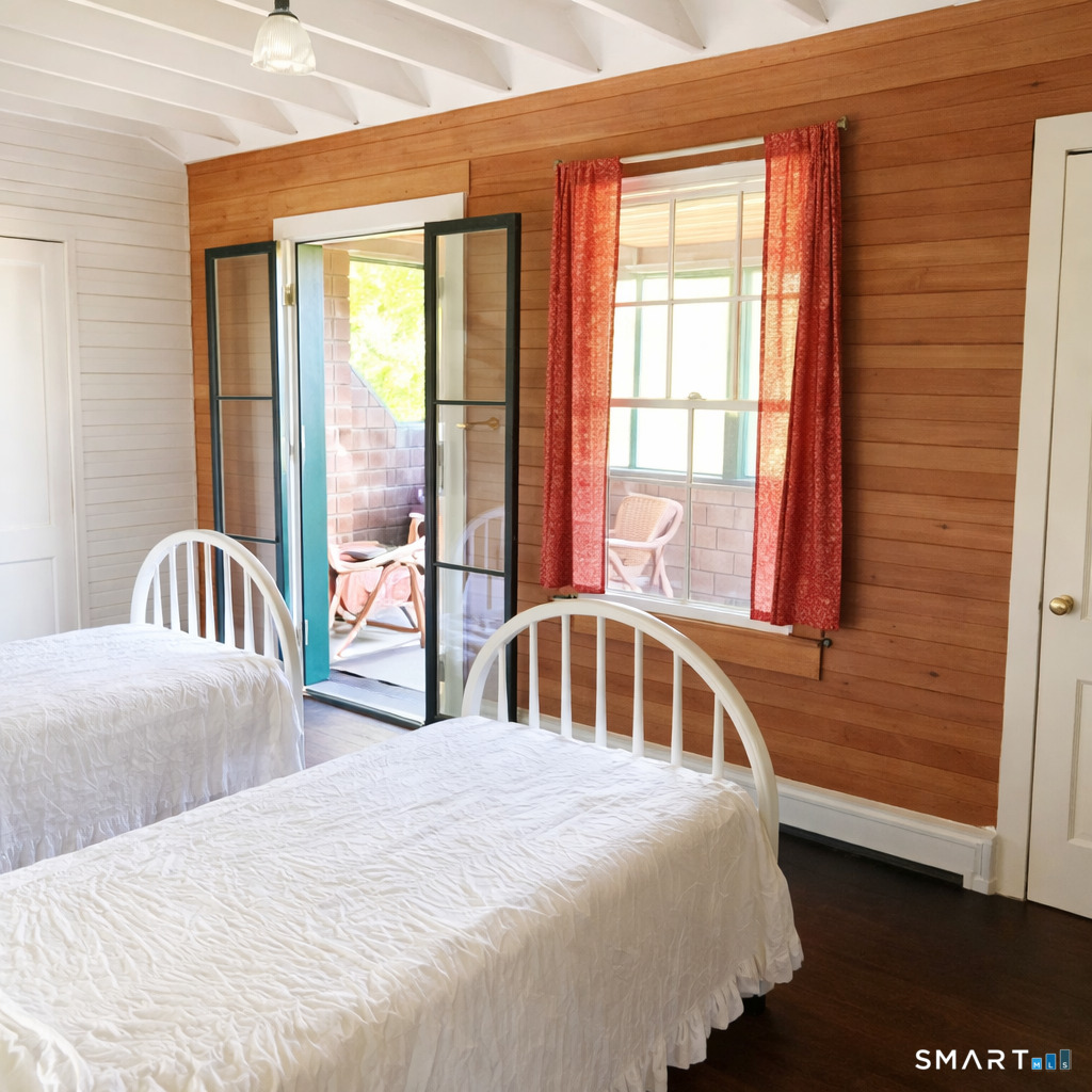 106 Buffalo Bay Road Madison, CT 06443 - Photo 12 of 17 a bedroom with a bed and a large window