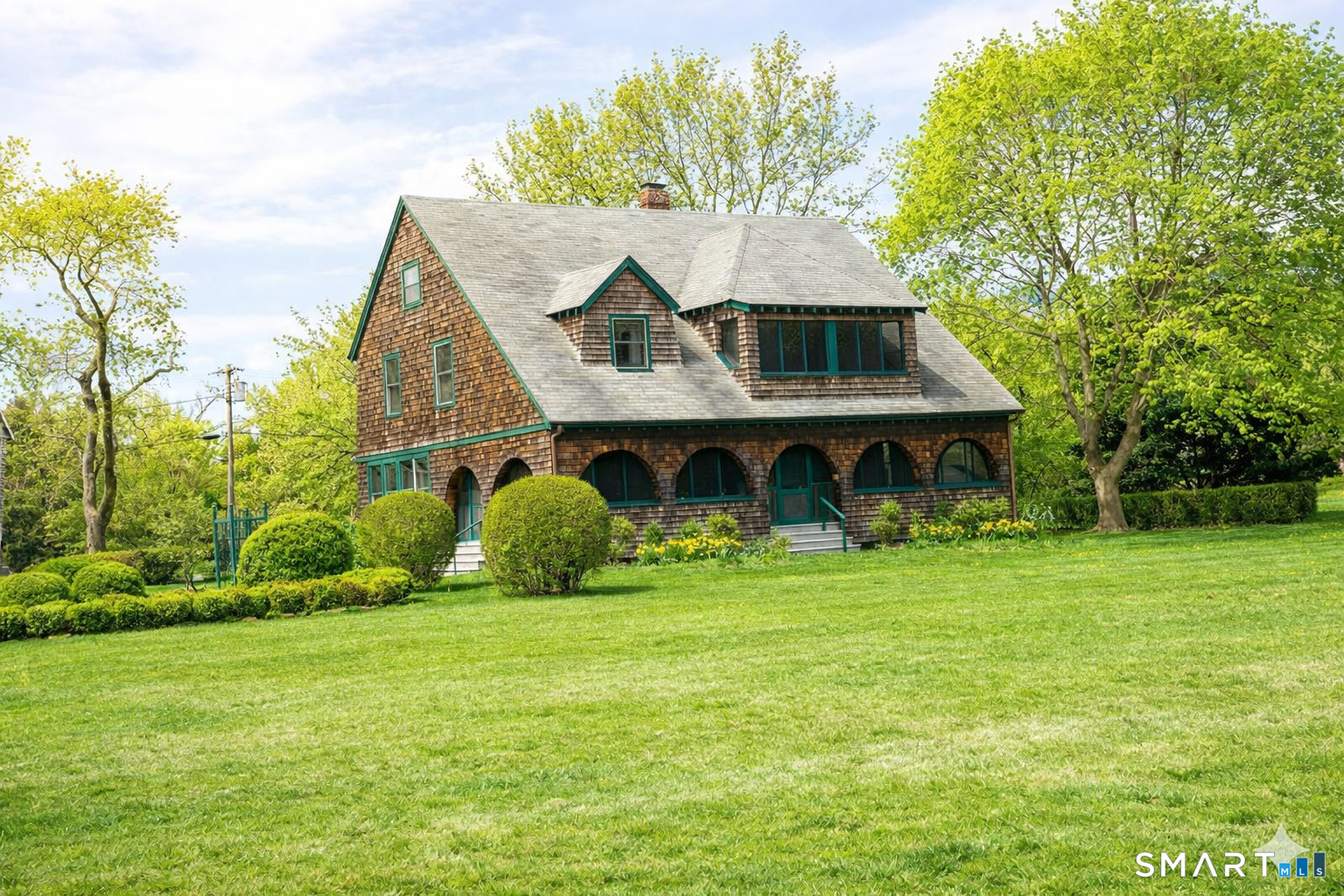106 Buffalo Bay Road Madison, CT 06443 - Photo 4 of 17 a front view of house with yard and green space