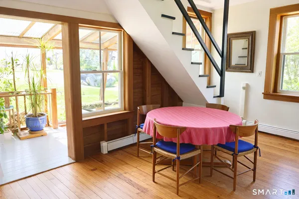 a bedroom with a bed a table and chair