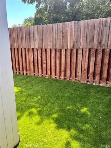 a view of yard with wooden fence