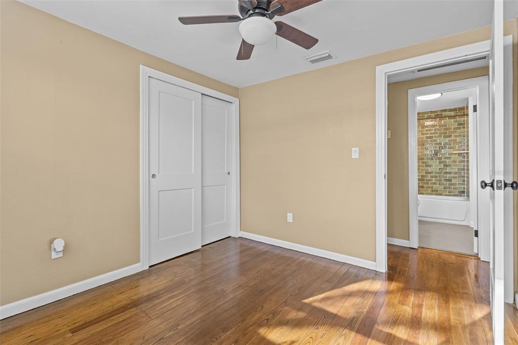 1908 West Fern Street Tampa, FL 33604 - Photo 25 of 47 a view of a room with wooden floor and a ceiling fan