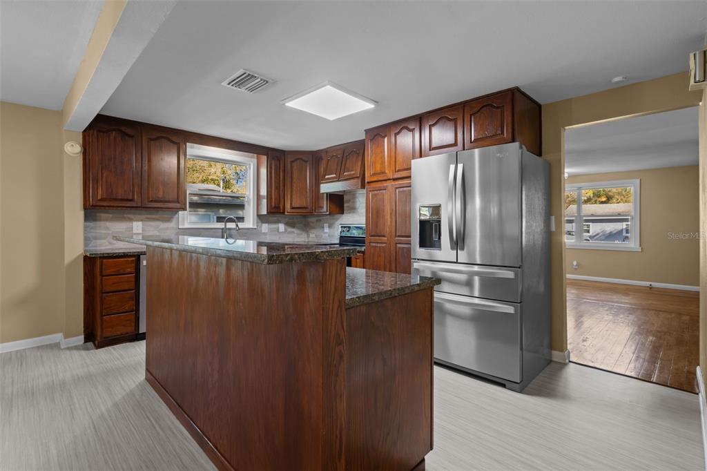 1908 West Fern Street Tampa, FL 33604 - Photo 10 of 47 a kitchen with kitchen island a counter top space cabinets and stainless steel appliances