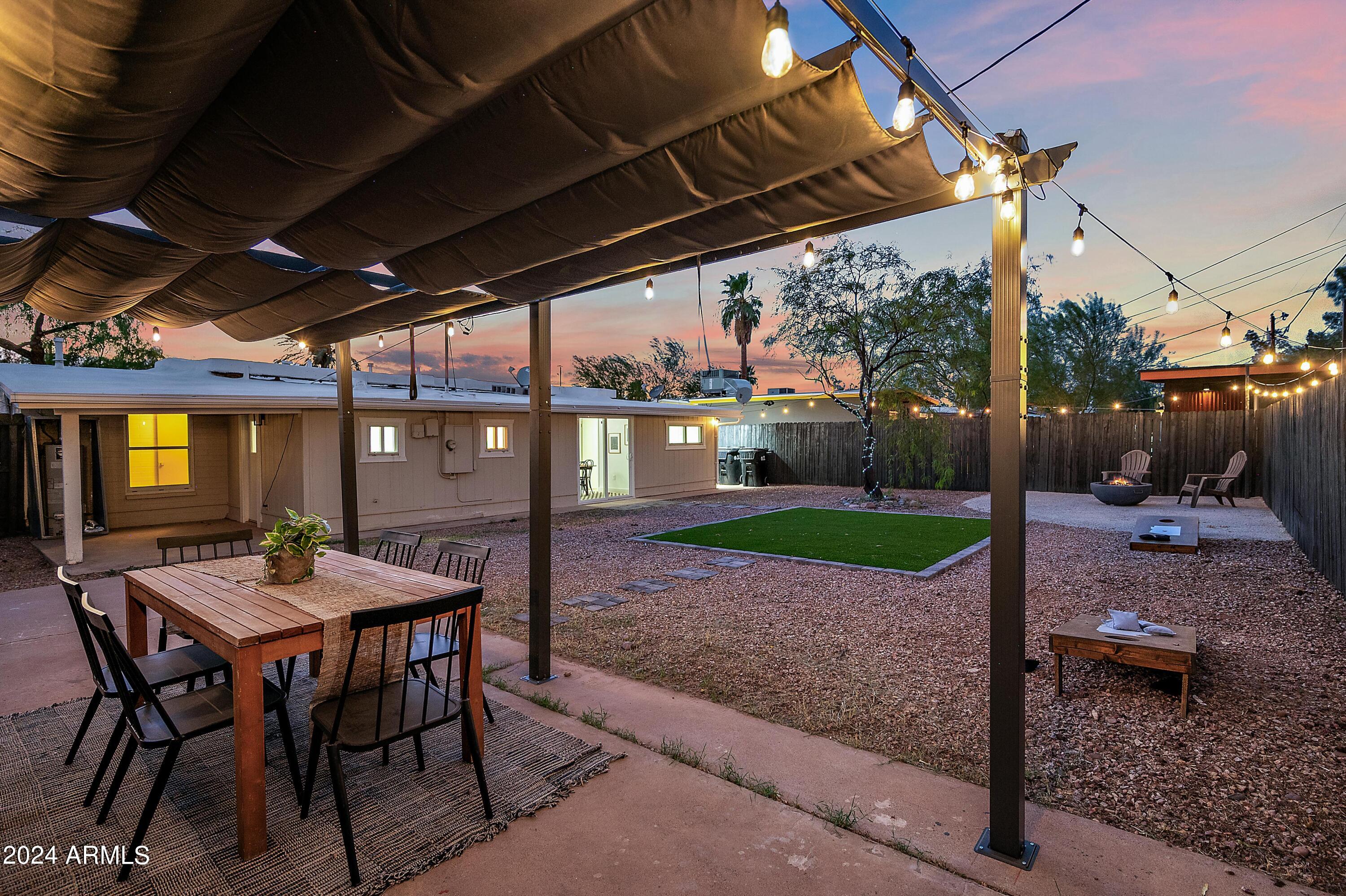 401 South Robert Road Tempe, AZ 85281 - Photo 26 of 35 a view of a patio with a table and chairs under a large umbrella