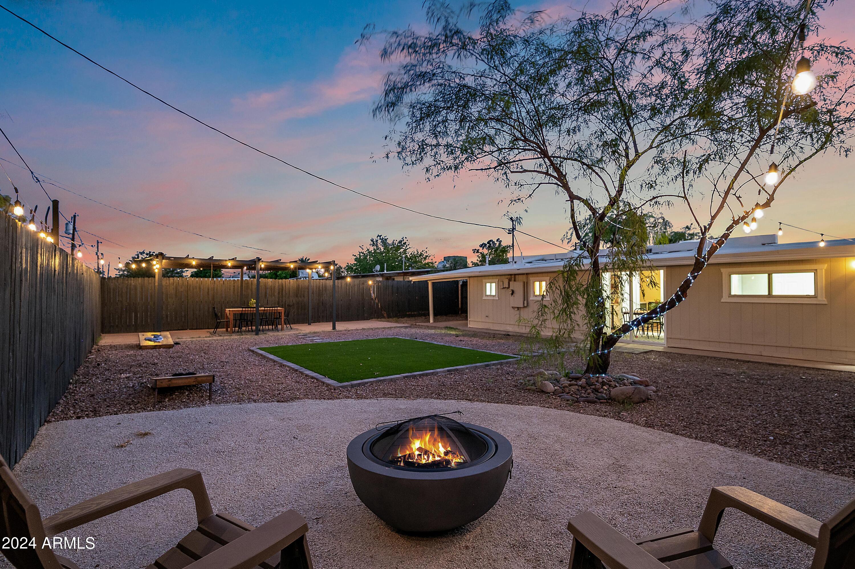 401 South Robert Road Tempe, AZ 85281 - Photo 3 of 35 a view of a backyard with table and chairs