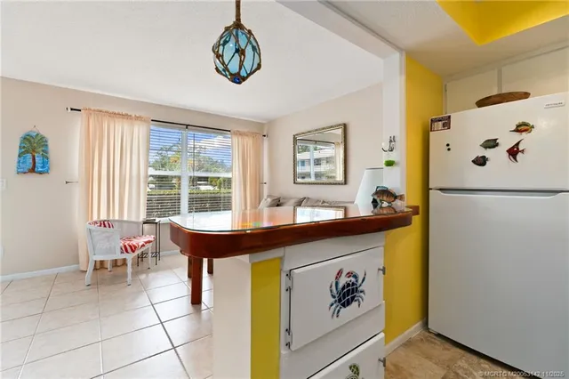 a kitchen with stainless steel appliances granite countertop a refrigerator sink and white cabinets