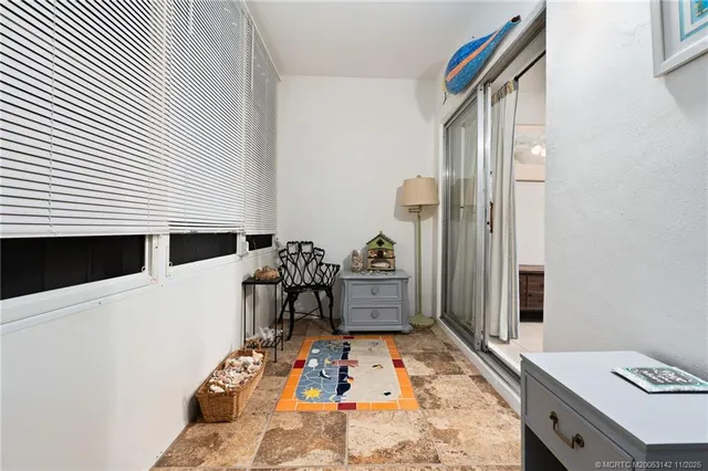 a bedroom with a bed and a chair in it