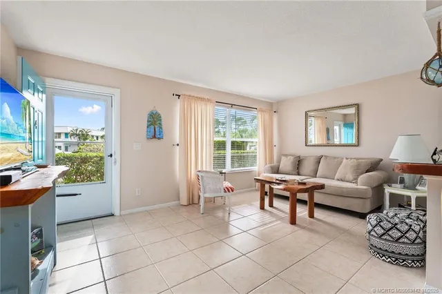 a living room with a table and chairs