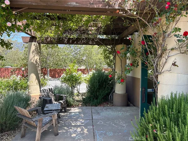 a backyard of a house with lots of green space and fountain