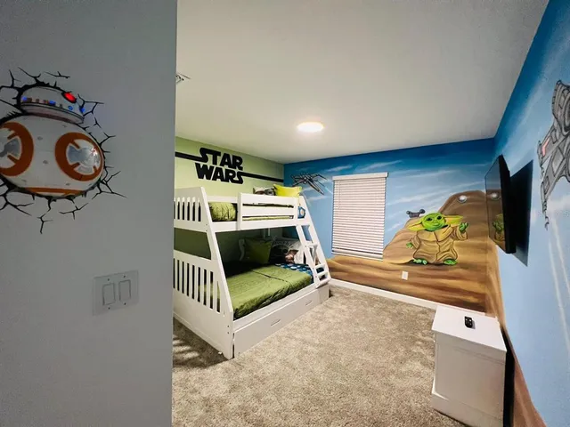 a bedroom with furniture and a window