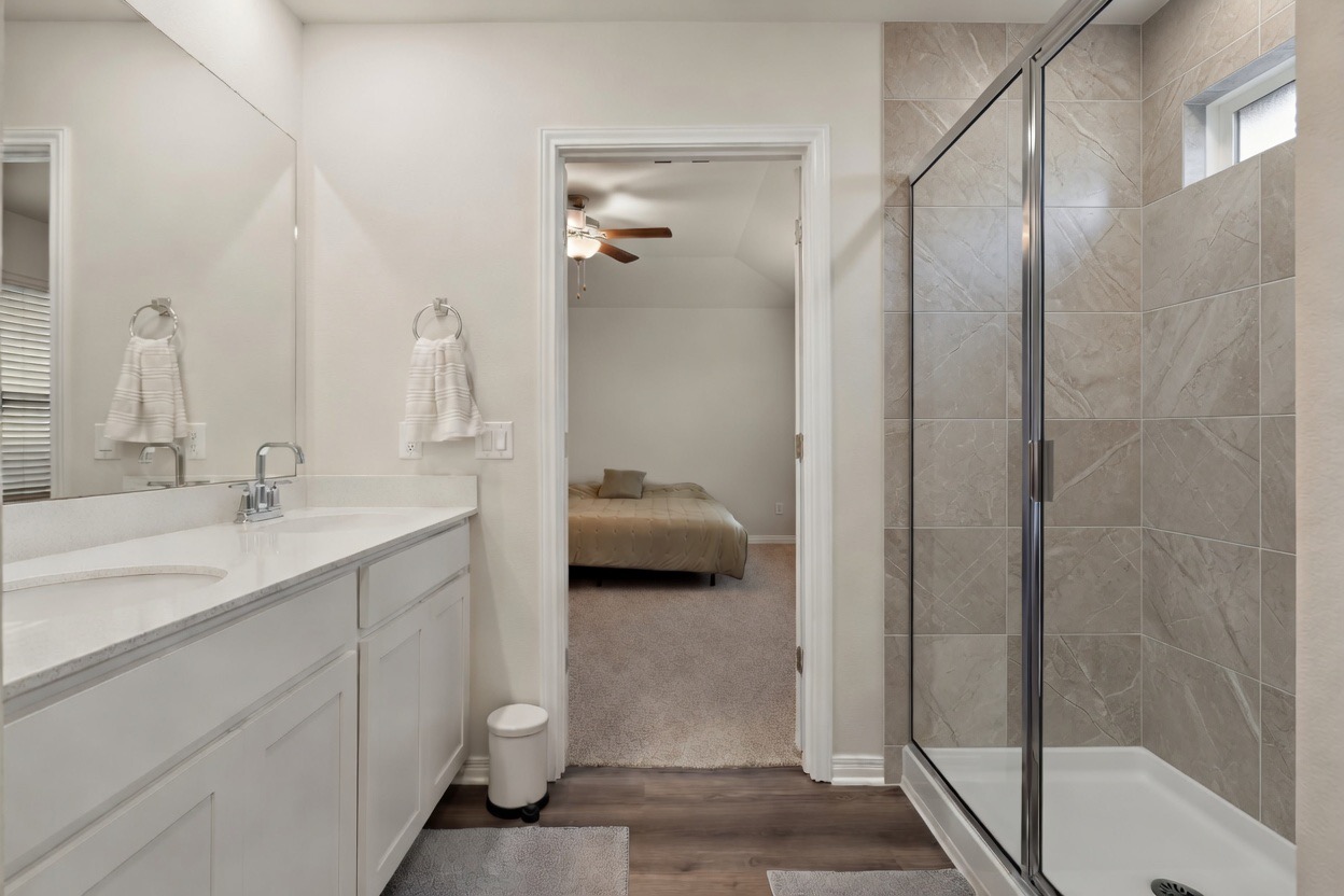 129 Greenway Drive Georgetown, TX 78628 - Photo 14 of 22 a en suite bathroom with a sink and a mirror
