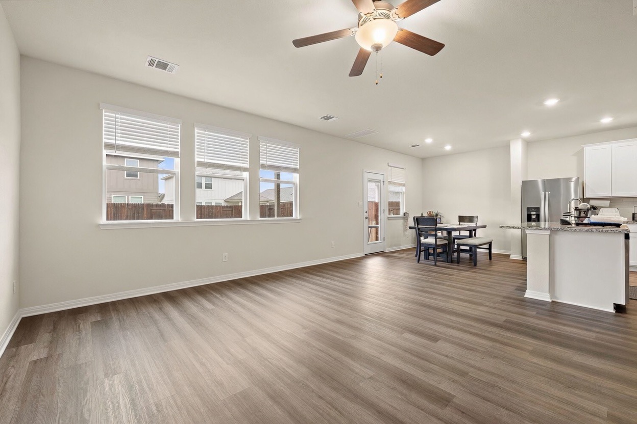 129 Greenway Drive Georgetown, TX 78628 - Photo 7 of 22 a view of an empty room with wooden floor and a window