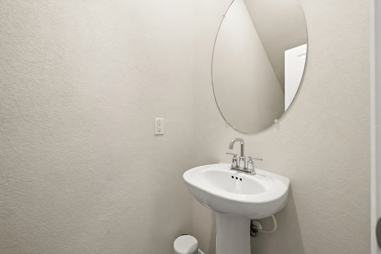 129 Greenway Drive Georgetown, TX 78628 - Photo 8 of 22 a bathroom with a sink and a mirror