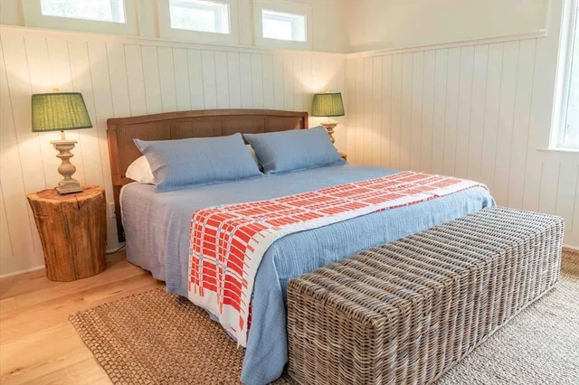 a bedroom with a bed and chair