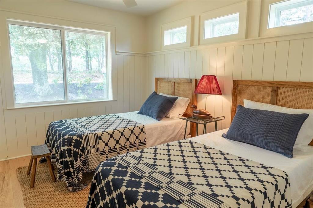 920 Cleve Cole Road Denison, TX 75021 - Photo 8 of 11 a bedroom with a bed and wooden floor