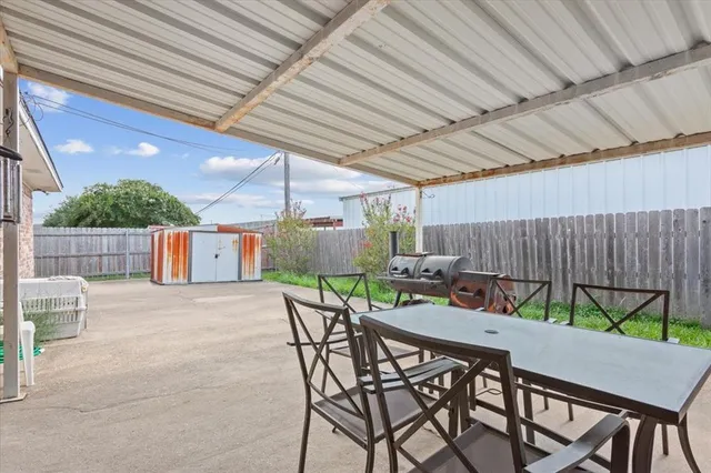 a patio with a table and chairs