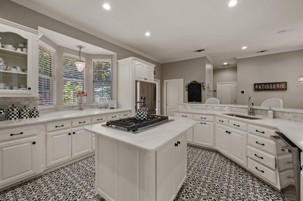 2906 Edgewood Lane Colleyville, TX 76034 - Photo 14 of 40 a kitchen with granite countertop a sink stove and cabinets