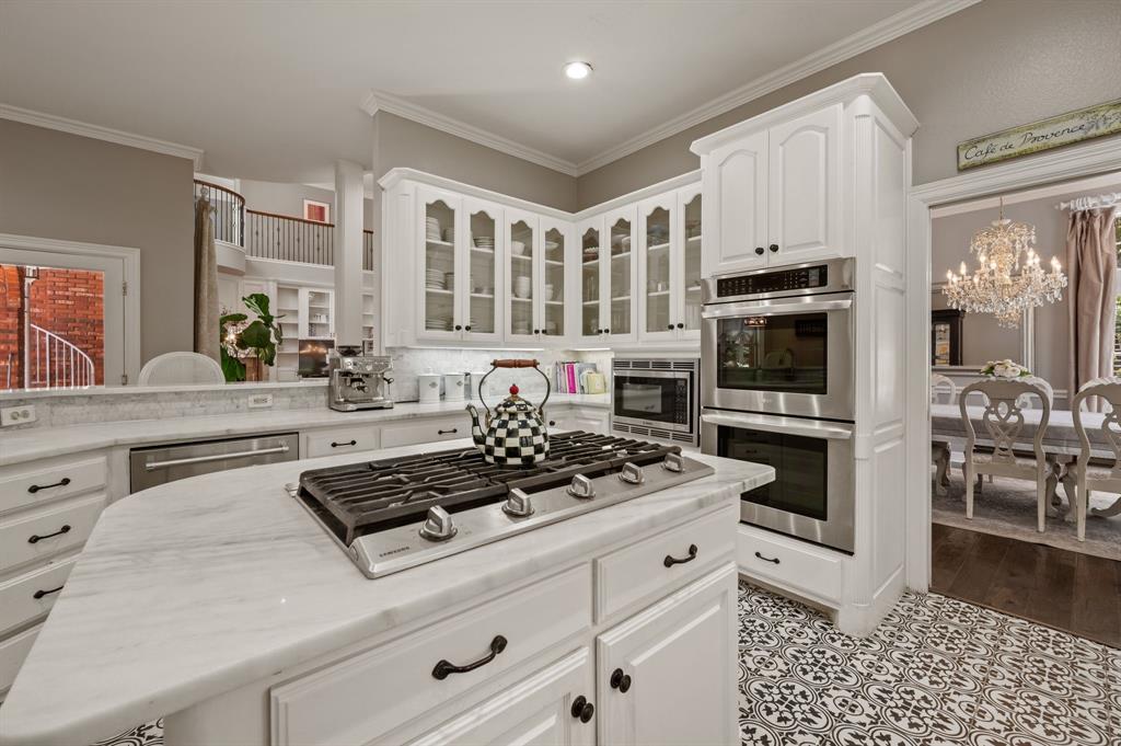 2906 Edgewood Lane Colleyville, TX 76034 - Photo 15 of 40 a kitchen with stainless steel appliances kitchen island granite countertop a stove and a sink