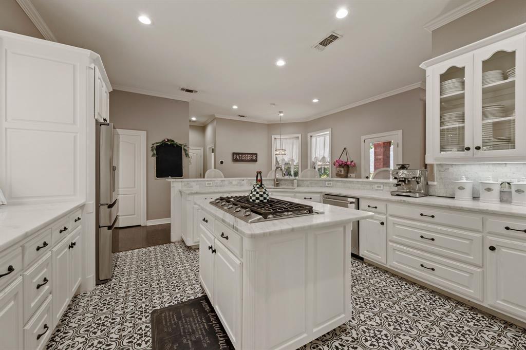 2906 Edgewood Lane Colleyville, TX 76034 - Photo 18 of 40 a kitchen with granite countertop appliances a sink and a refrigerator