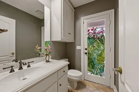 a bathroom with a toilet sink and mirror