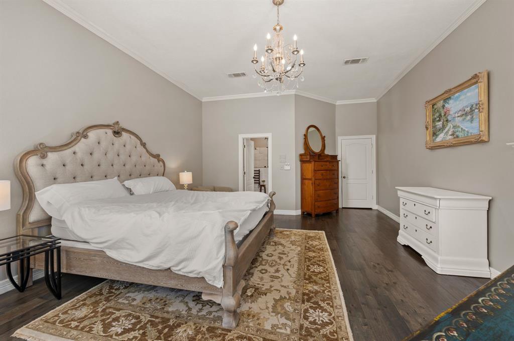 2906 Edgewood Lane Colleyville, TX 76034 - Photo 23 of 40 a bedroom with a bed and wooden floor