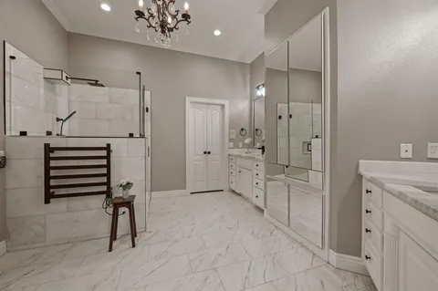 a spacious bathroom with a shower a sink and a mirror