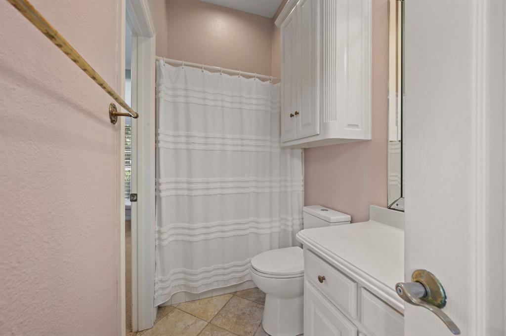2906 Edgewood Lane Colleyville, TX 76034 - Photo 28 of 40 a bathroom with a toilet and a shower