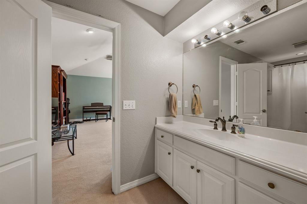 2906 Edgewood Lane Colleyville, TX 76034 - Photo 31 of 40 a en suite bathroom with double sink and a mirror
