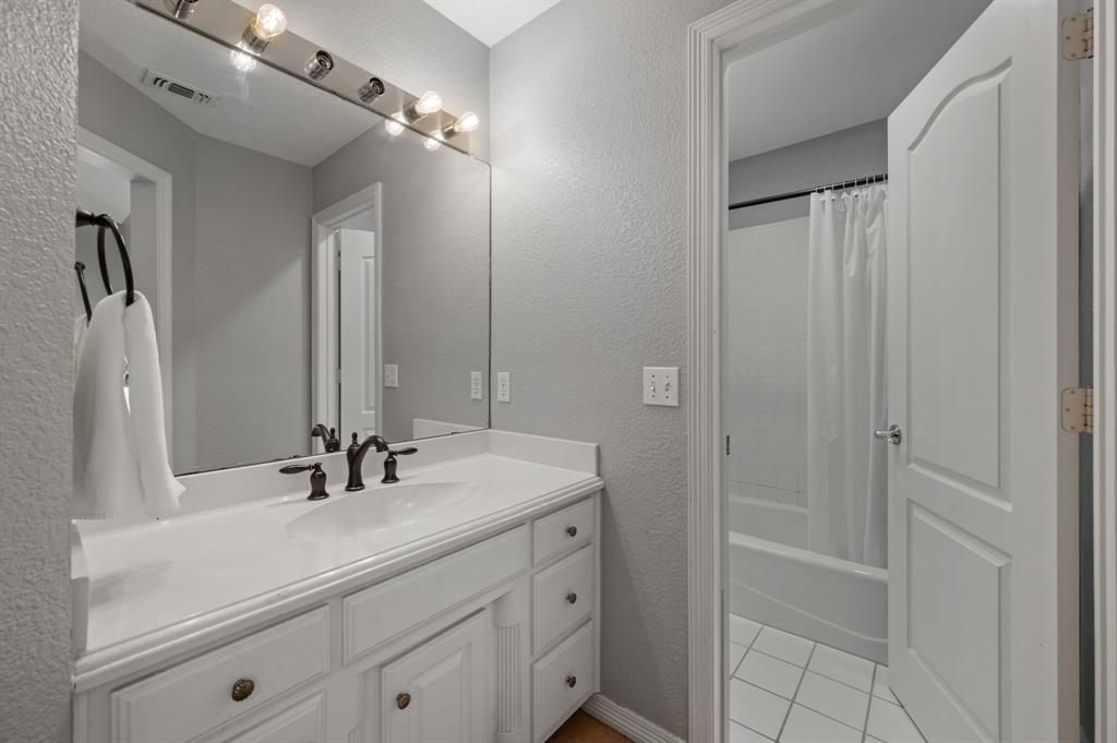 2906 Edgewood Lane Colleyville, TX 76034 - Photo 35 of 40 a bathroom with a double vanity sink a mirror and shower