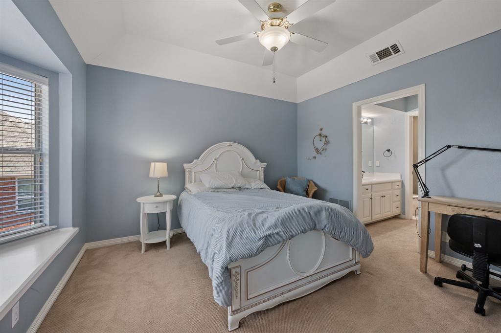 2906 Edgewood Lane Colleyville, TX 76034 - Photo 36 of 40 a bedroom with a bed and a chandelier