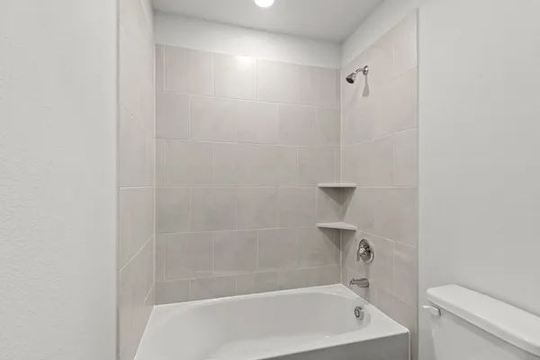 a bathroom with a bathtub and toilet