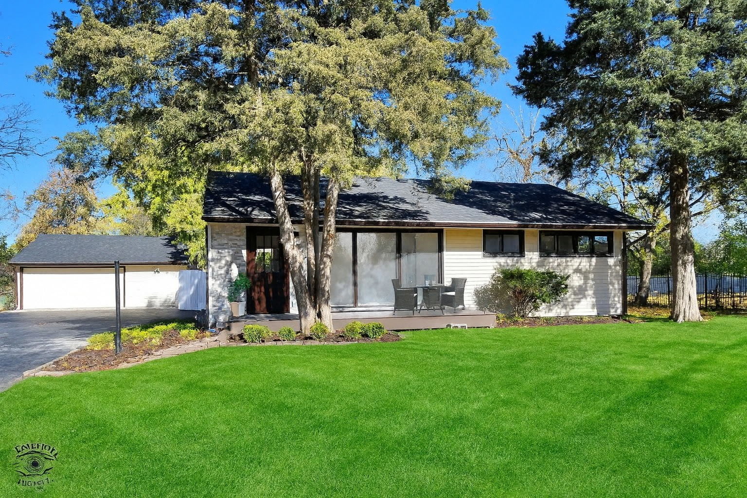 a front view of a house with a yard porch and patio