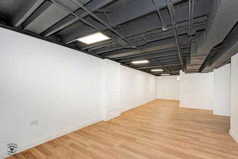 a bedroom with a large bed and a chair