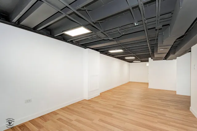 a bedroom with a large bed and a chair